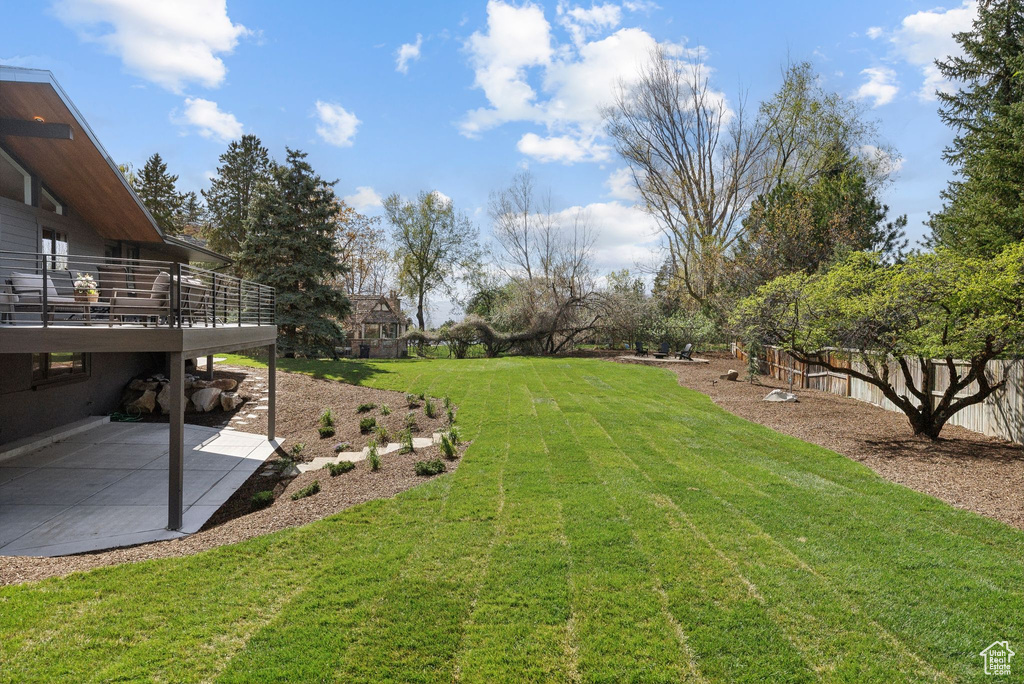View of yard featuring a patio and fence