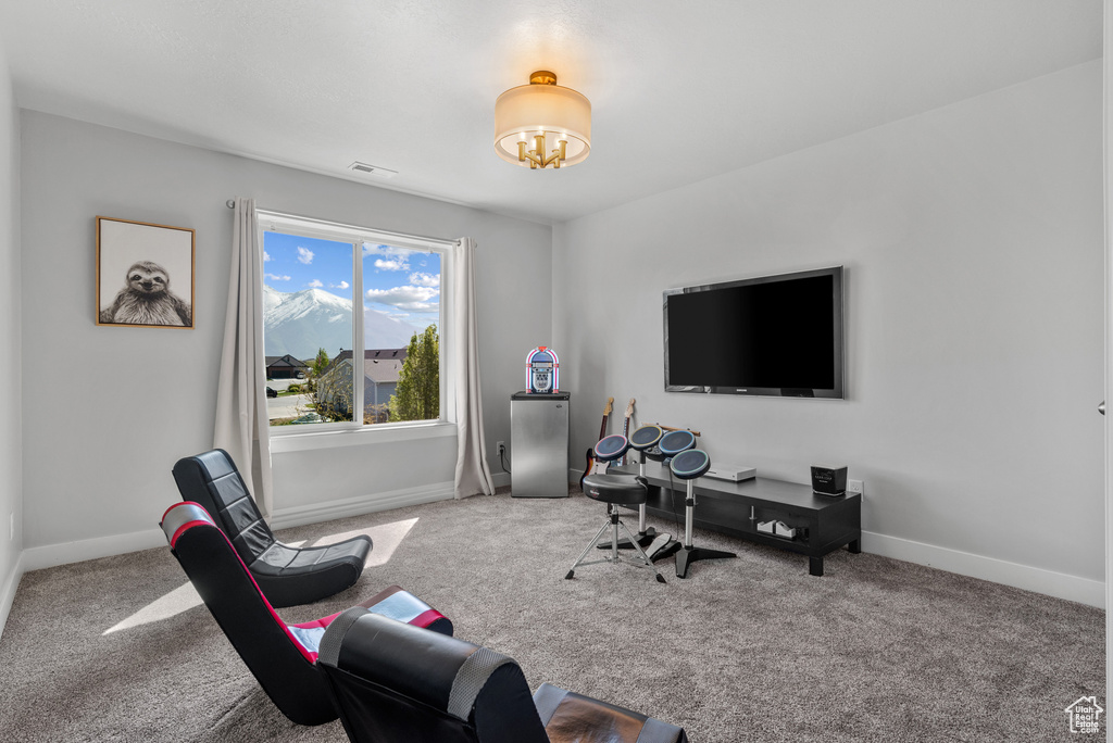 Office space featuring baseboards, an inviting chandelier, visible vents, and carpet