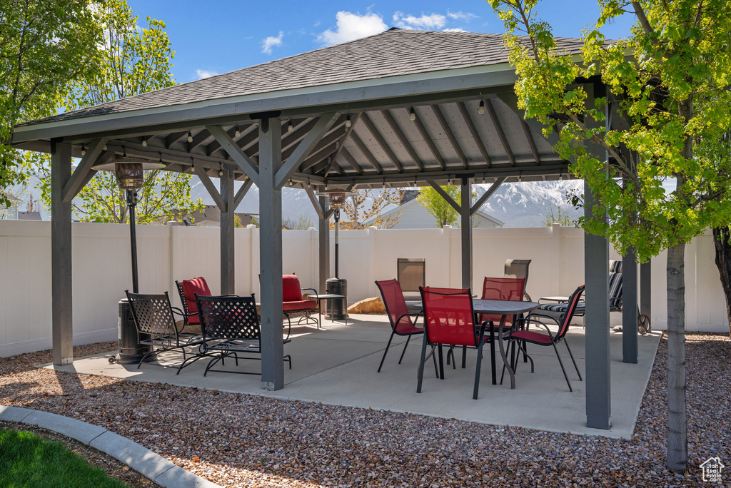 View of patio with fence and a gazebo