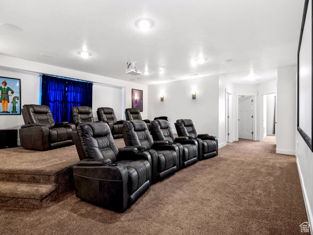 Carpeted cinema featuring baseboards and visible vents
