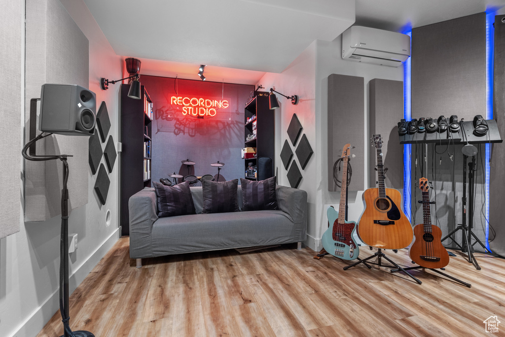 Interior space featuring wood finished floors and a wall mounted AC