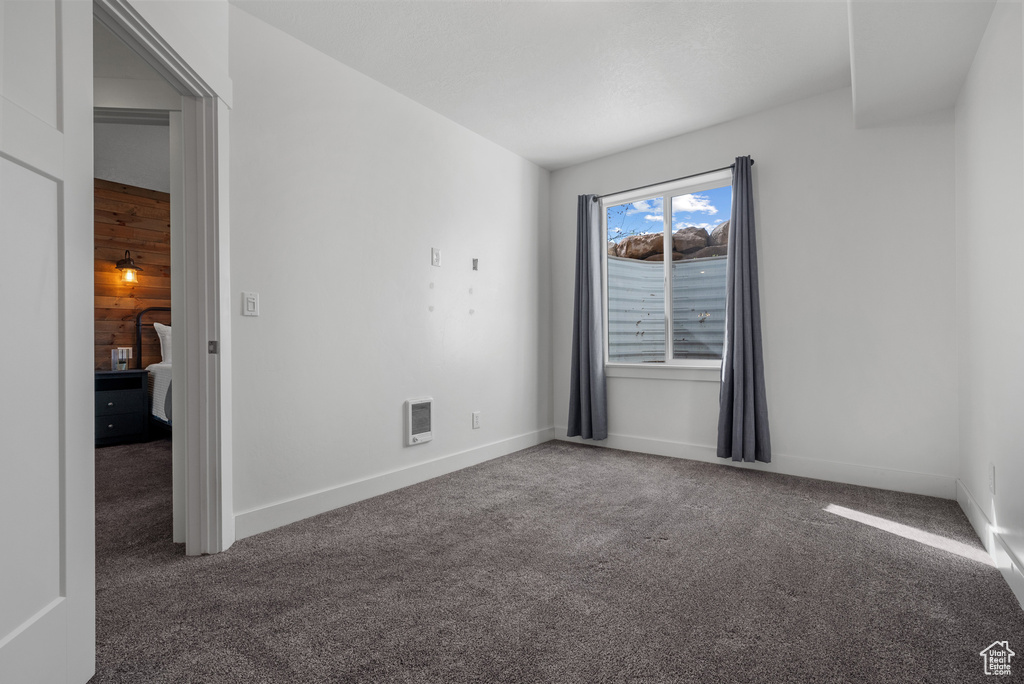 Spare room with visible vents, carpet flooring, and baseboards