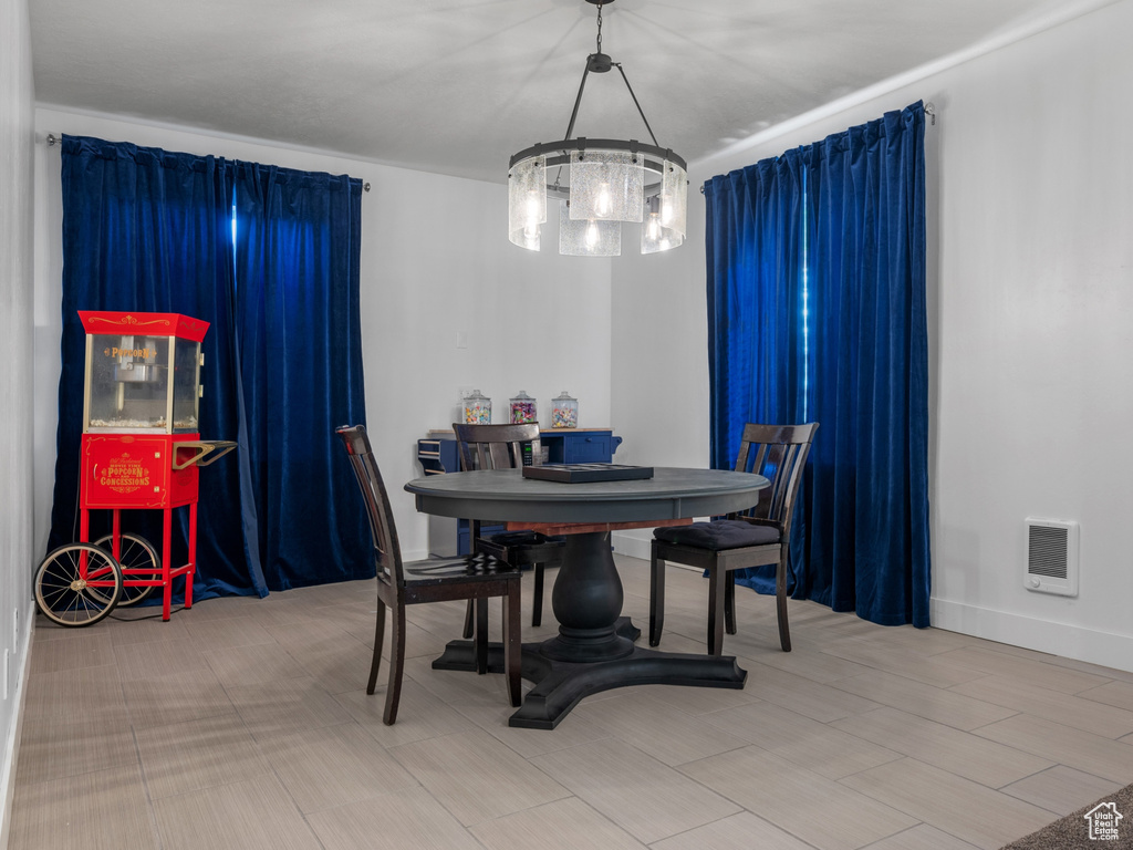 Dining space featuring heating unit and an inviting chandelier