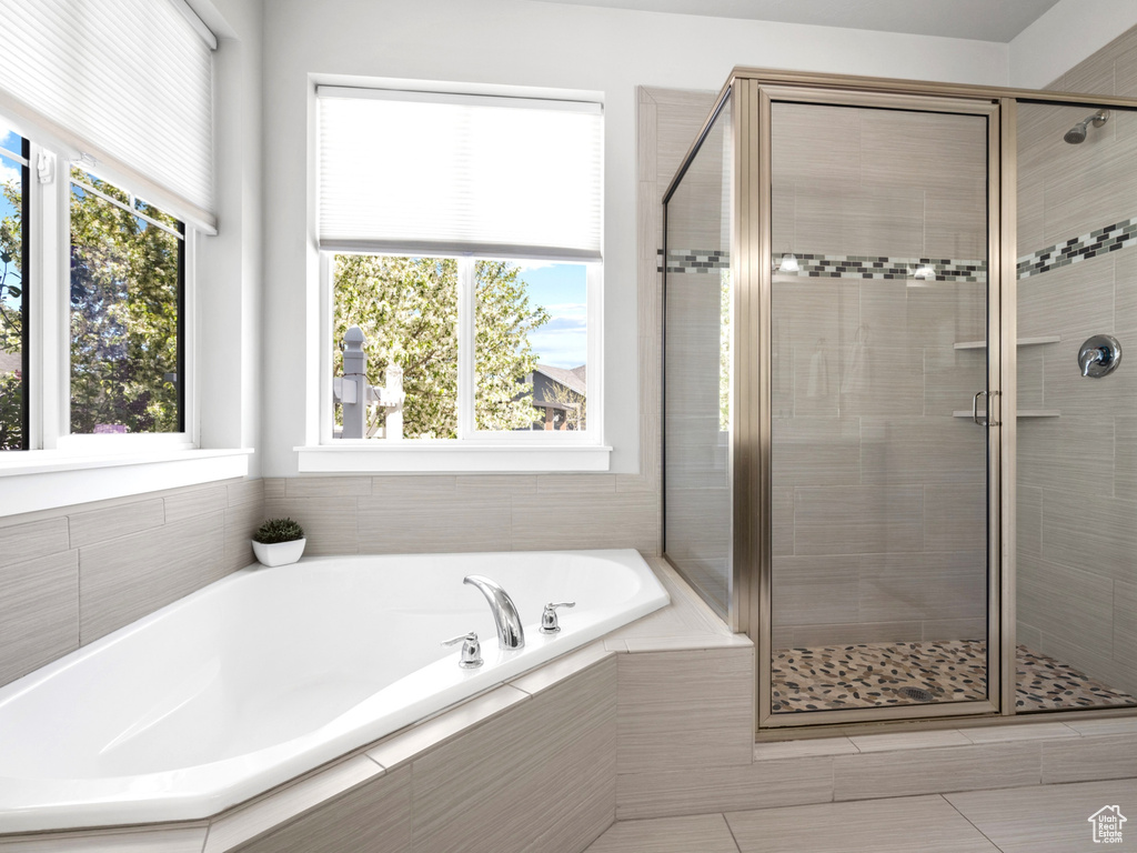 Full bath featuring a garden tub and a stall shower
