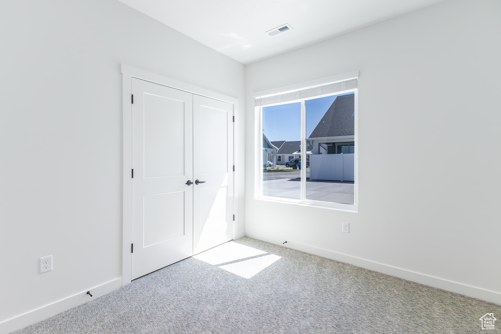 Unfurnished bedroom featuring carpet floors and a closet