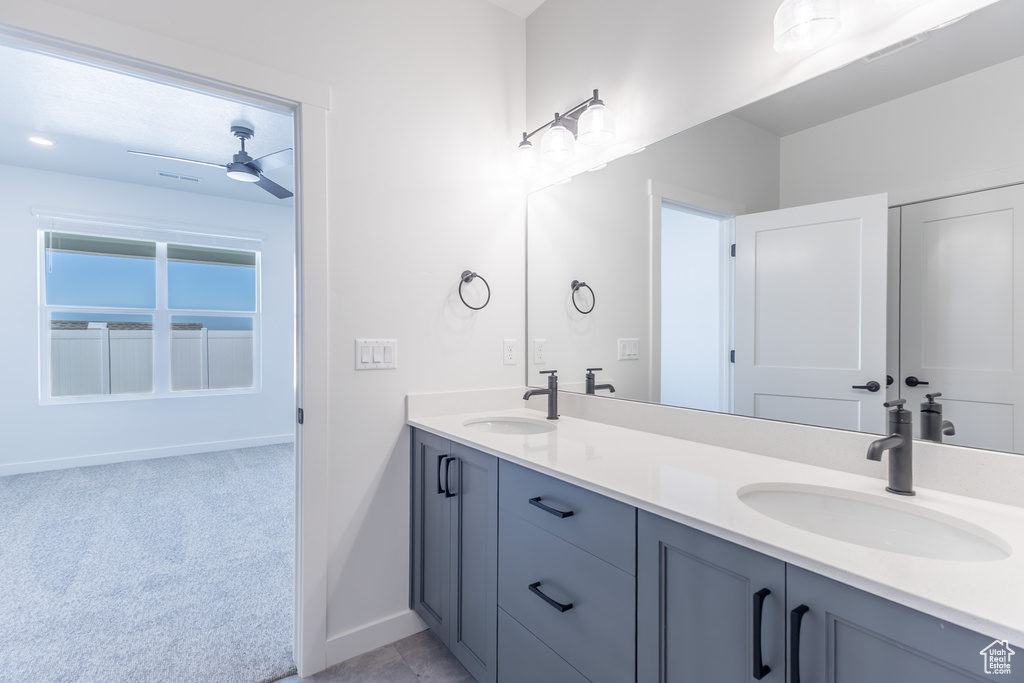 Full bath with double vanity and ceiling fan