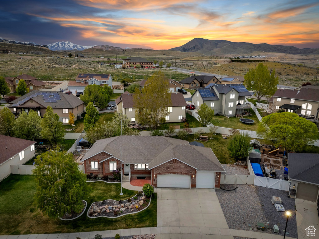 Aerial view at dusk featuring a residential view and a mountain view