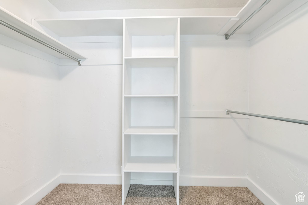 Spacious closet with carpet floors