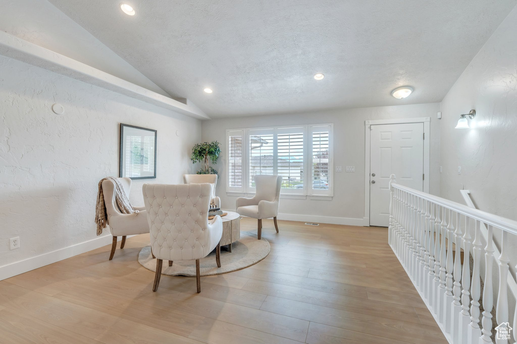 Dining area featuring lofted ceiling, light wood-style flooring, baseboards, and recessed lighting