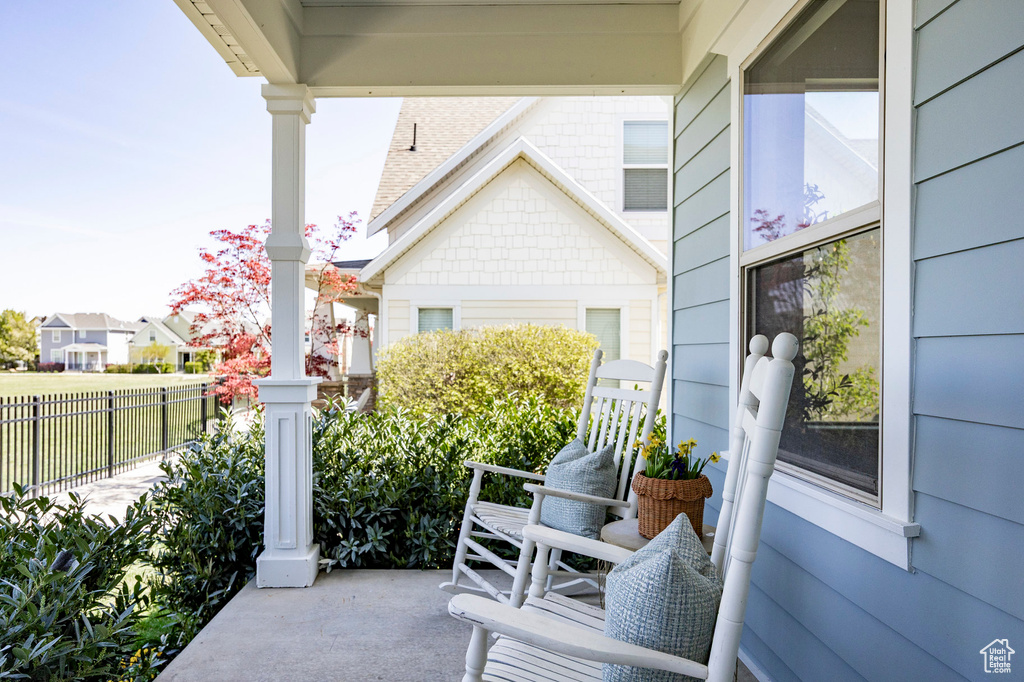 View of patio / terrace with a porch and fence