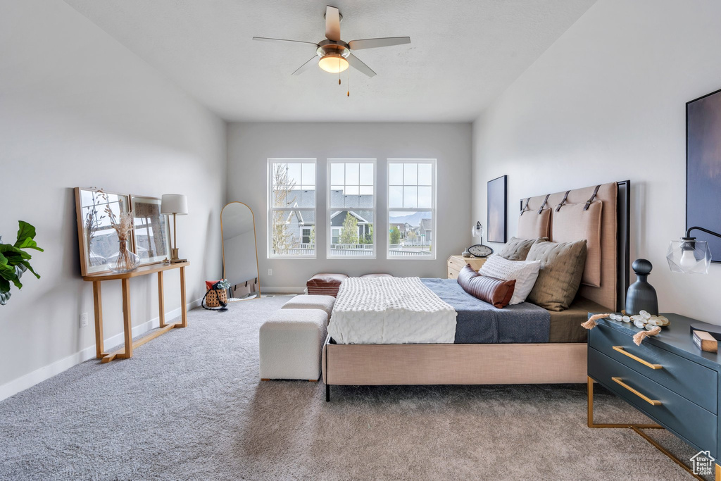 Bedroom with baseboards, carpet flooring, and ceiling fan