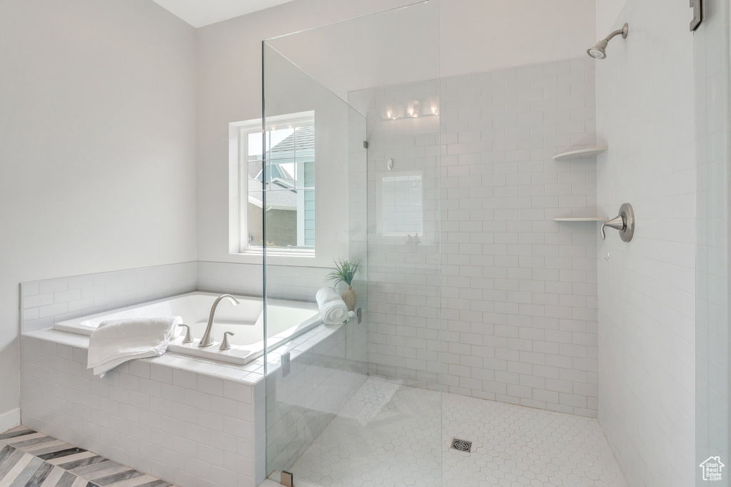 Full bath featuring tile patterned floors, a garden tub, and a shower stall