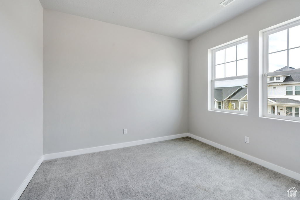 Carpeted empty room with baseboards