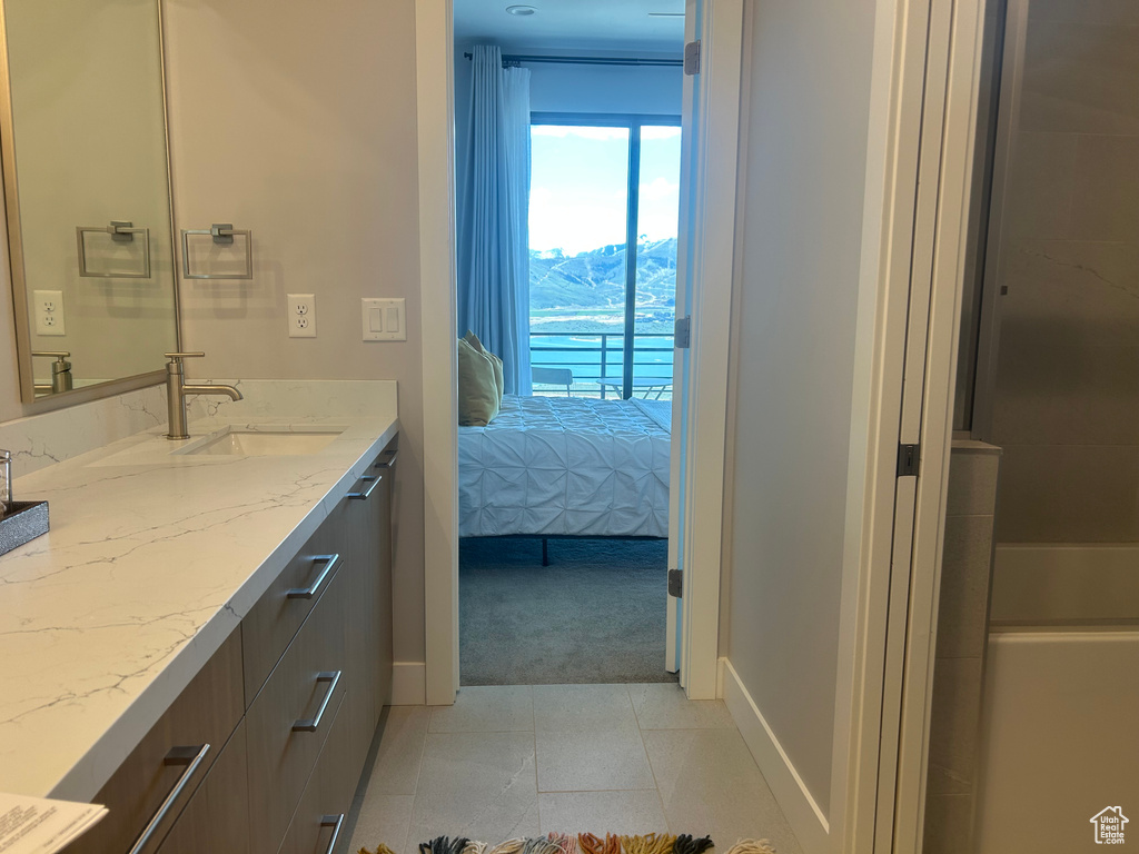 Ensuite bathroom with vanity and baseboards