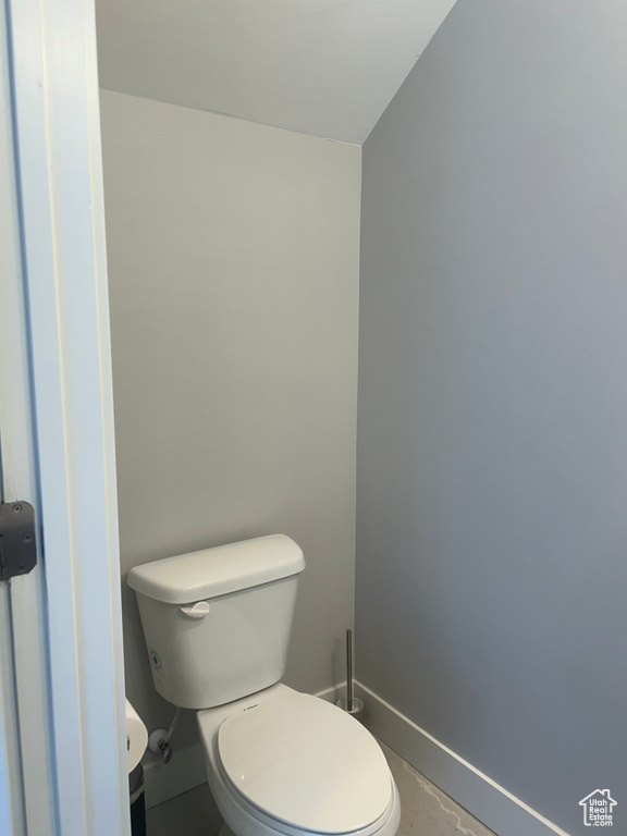 Bathroom featuring baseboards and toilet