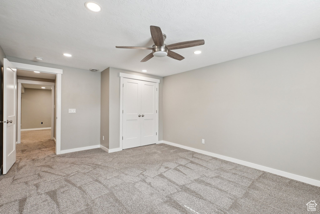 Unfurnished bedroom featuring carpet floors, recessed lighting, baseboards, and a closet