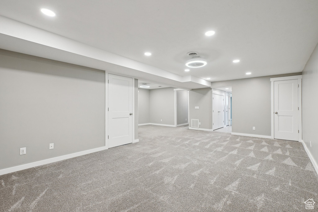 Finished below grade area featuring baseboards, carpet, recessed lighting, and visible vents