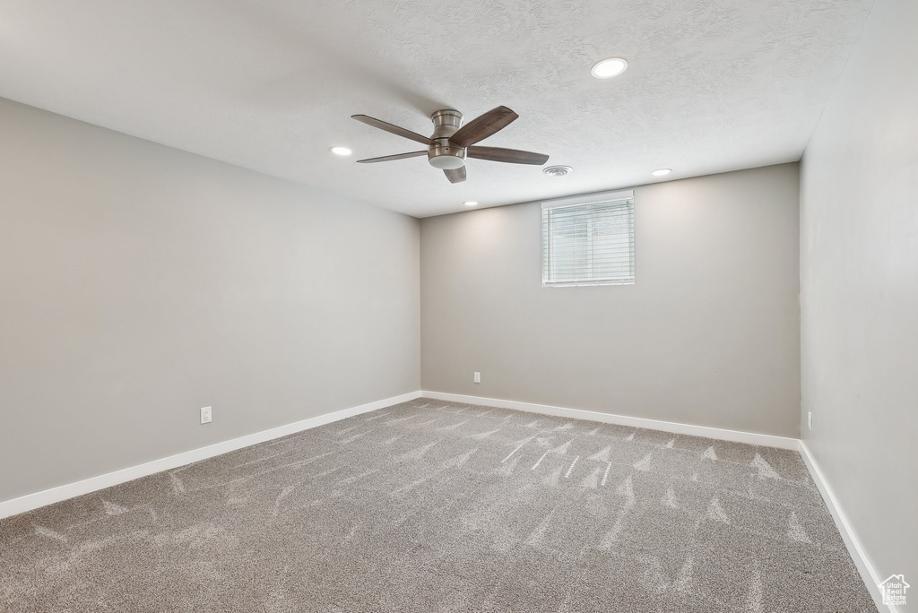 Carpeted spare room with baseboards, ceiling fan, and recessed lighting