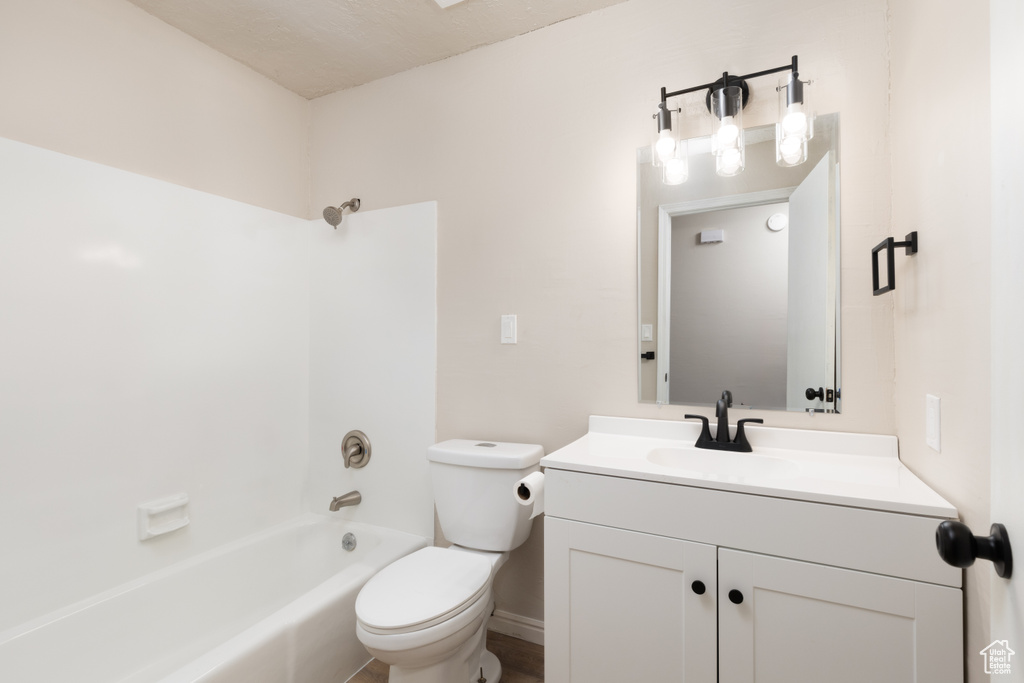 Full bathroom with toilet, vanity, and shower / bathing tub combination