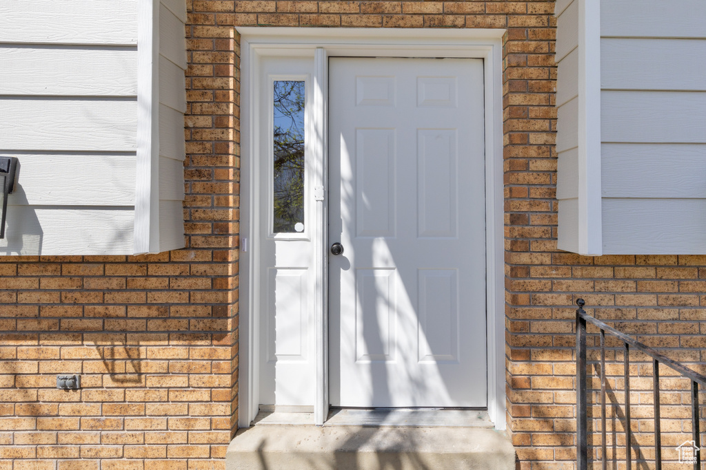 Entrance to property with brick siding