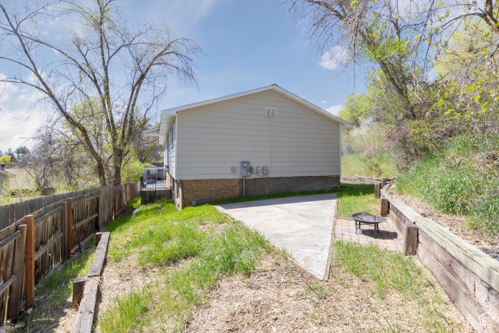 View of yard with fence and a patio area