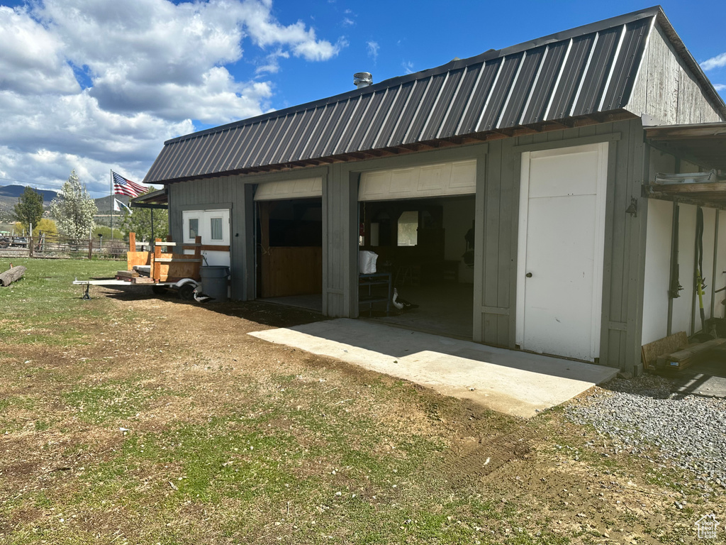 Rear view of house with an outbuilding and metal roof