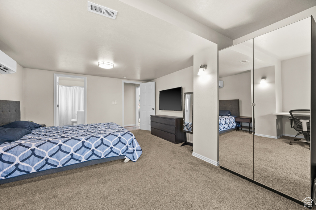 Carpeted bedroom with baseboards and visible vents