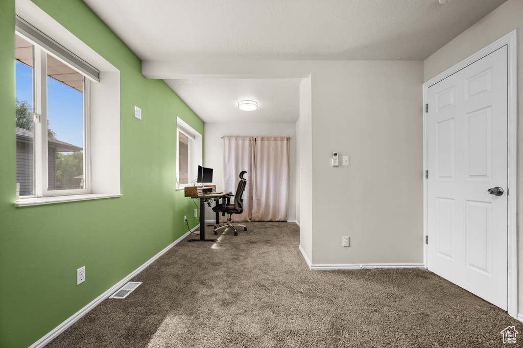 Unfurnished office with carpet, visible vents, and baseboards