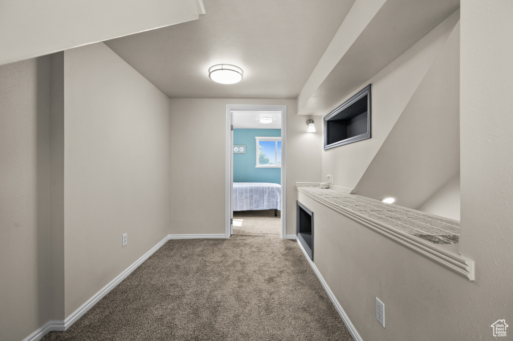 Hallway with baseboards and carpet flooring
