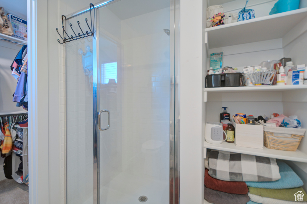 Bathroom with a spacious closet and a shower stall
