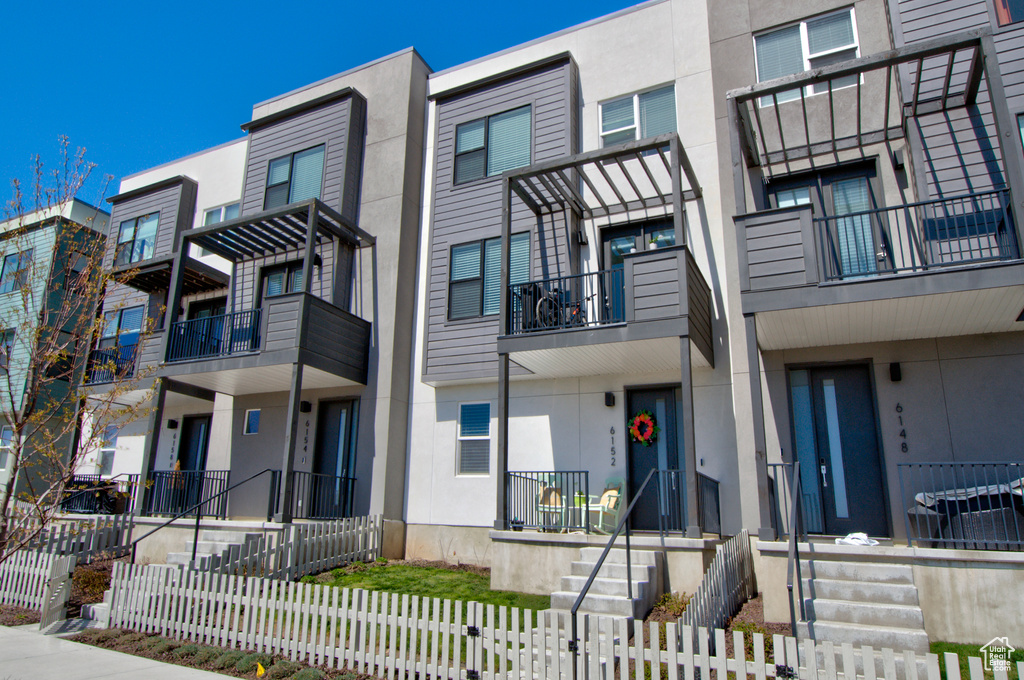 View of building exterior featuring a fenced front yard