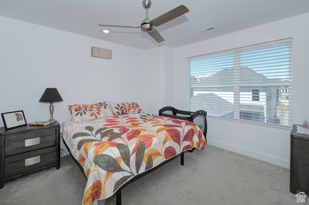 Bedroom featuring carpet floors, a ceiling fan, visible vents, and baseboards