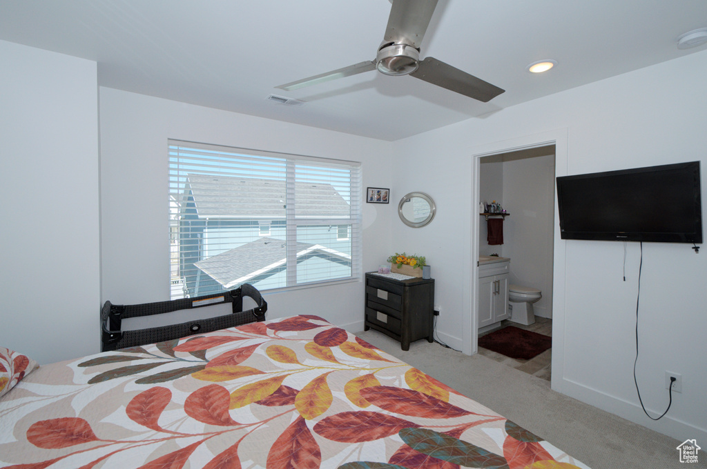 Bedroom with recessed lighting, visible vents, connected bathroom, light colored carpet, and ceiling fan