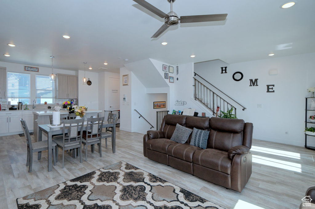 Living area with light wood-style floors and recessed lighting