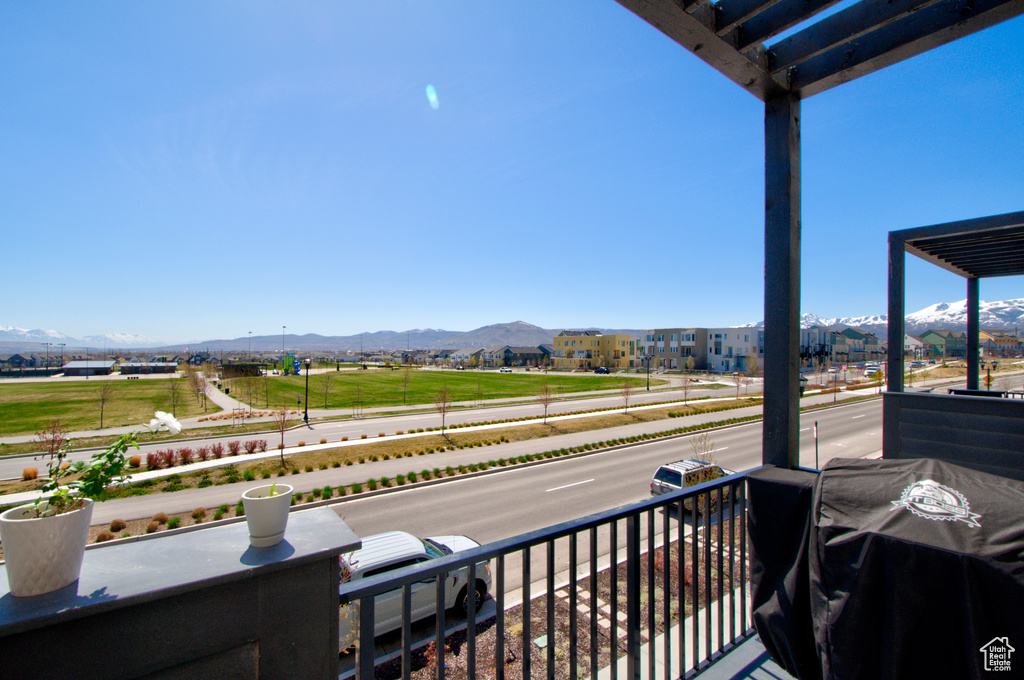 Balcony featuring grilling area and a mountain view