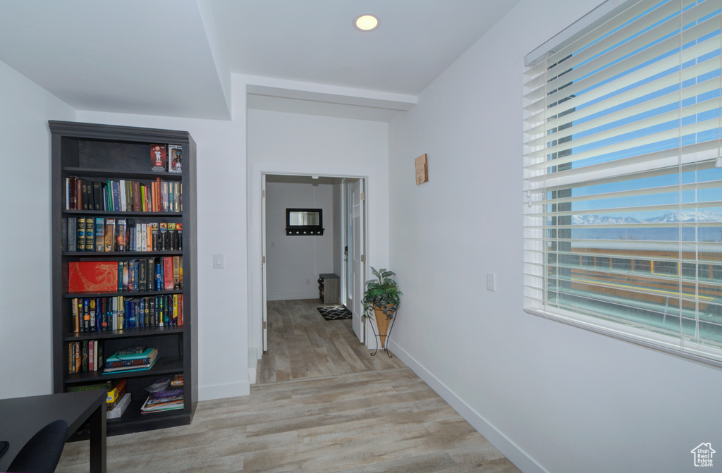 Hall featuring recessed lighting, baseboards, and light wood-type flooring