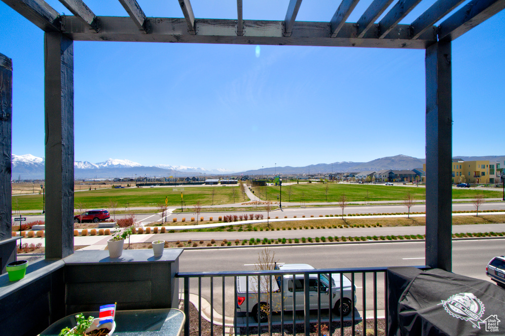 View of patio featuring a balcony and a mountain view