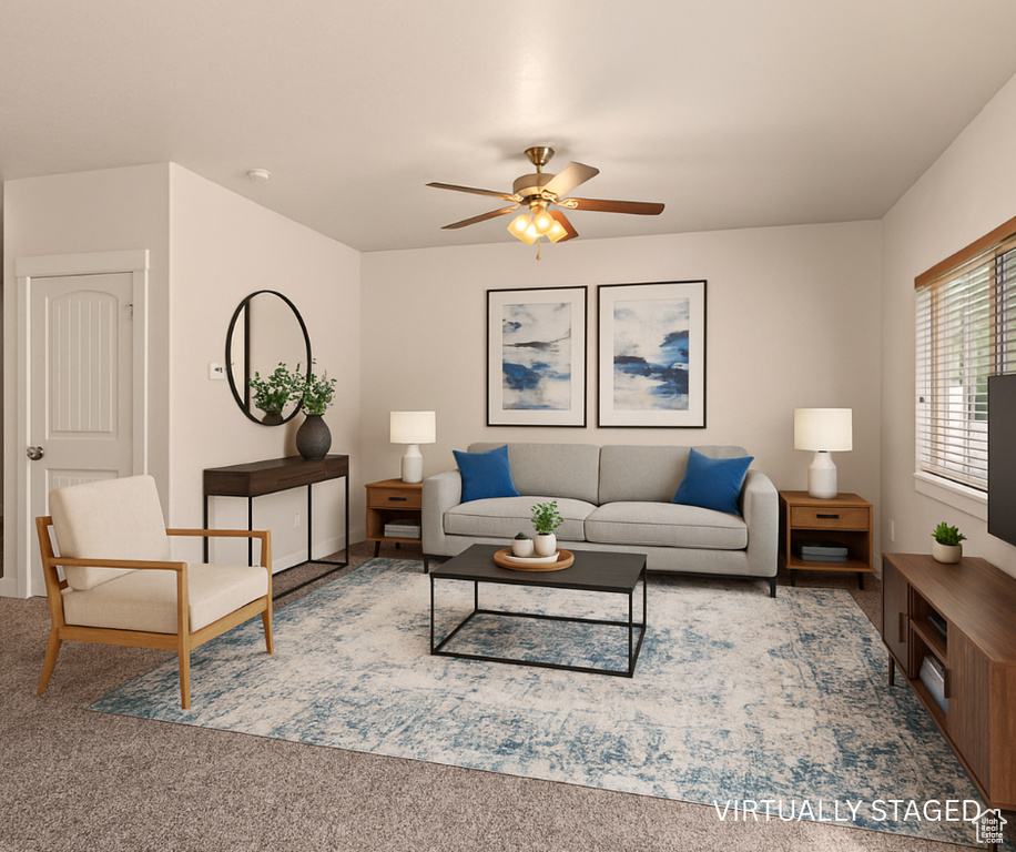Living area featuring a ceiling fan, carpet floors, and baseboards