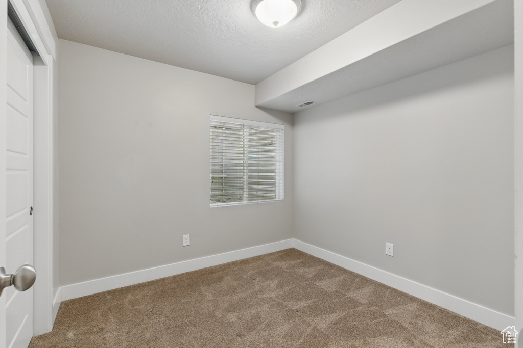 Interior space with visible vents, baseboards, and a textured ceiling