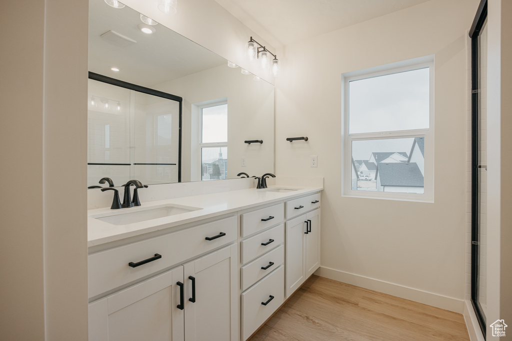 Bathroom with plenty of natural light, baseboards, and a sink