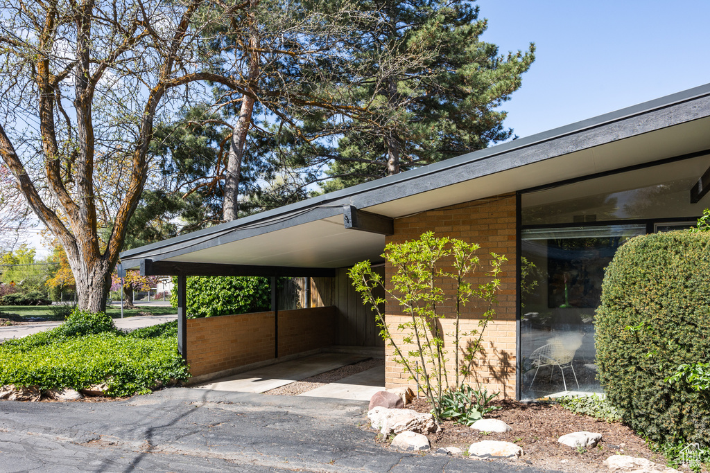 View of parking / parking lot with an attached carport