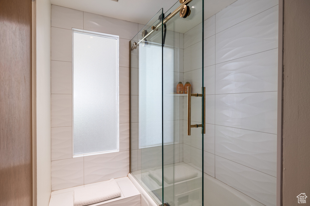 Full bath featuring a shower with door