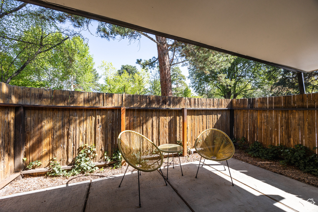 View of patio with a fenced backyard