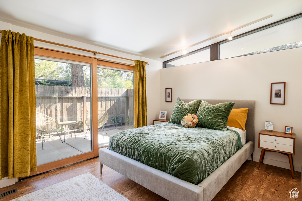 Bedroom featuring access to outside and visible vents