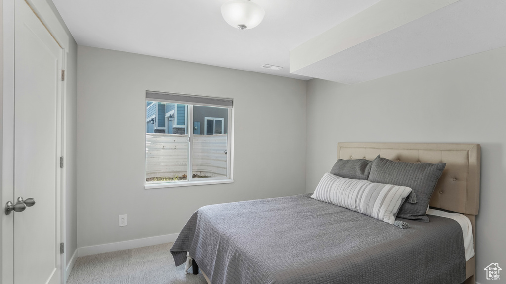 Bedroom with baseboards and carpet