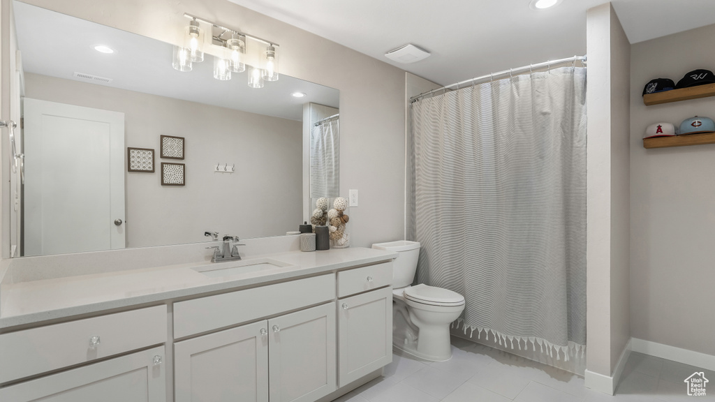 Full bathroom with recessed lighting, tile patterned floors, visible vents, toilet, and vanity