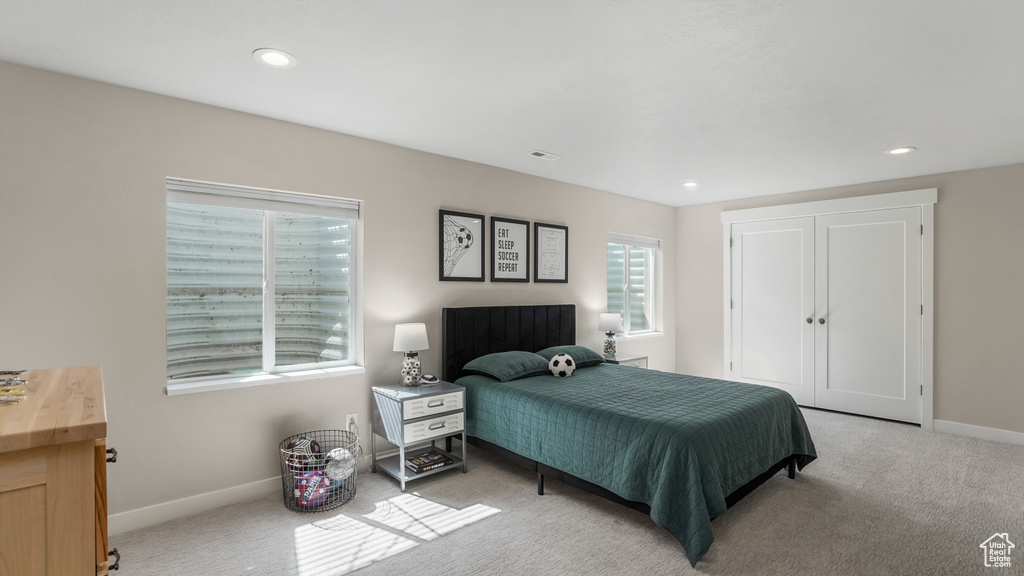 Bedroom featuring recessed lighting, baseboards, a closet, and light colored carpet