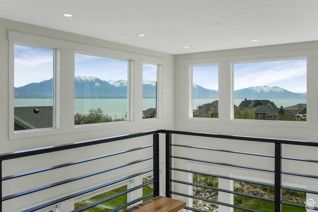 Interior space featuring a water and mountain view and a healthy amount of sunlight