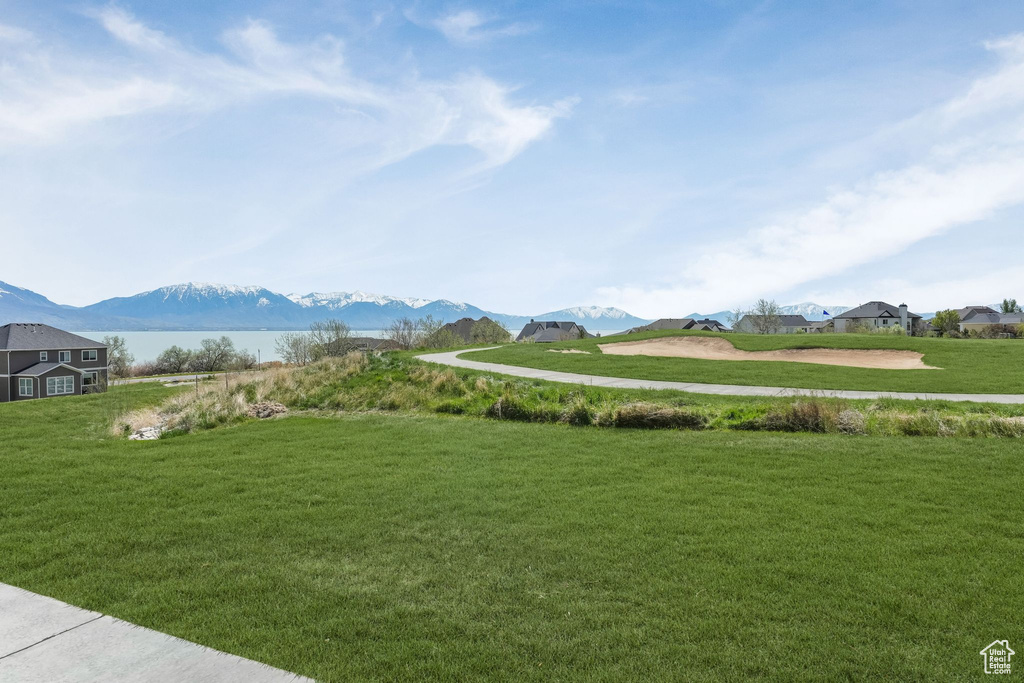 View of community featuring a lawn and a mountain view