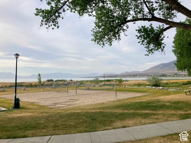 View of community with a rural view, a yard, volleyball court, and a mountain view